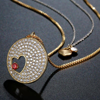 Side angle view of KHAISTA double heart forever love gold CZ necklace