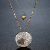 Pendant detail on KHAISTA double heart forever love gold CZ necklace