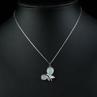Side angle view of KHAISTA crystal dragonfly pendant necklace