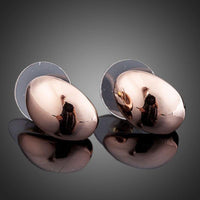 Close up of KHAISTA egg shape crystal stud earrings