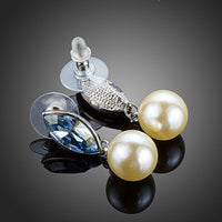 Close up of KHAISTA fancy pearl drop earrings