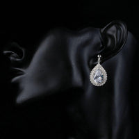 Side angle view of KHAISTA fashion CZ drop earrings