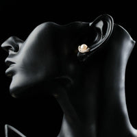 Close up of KHAISTA pearl half ellipse rhinestone stud earrings