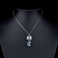 Side angle view of KHAISTA crystal fish design pendant necklace