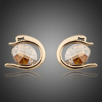 KHAISTA crystal fish porpoising stud earrings on white background