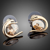 Close up of KHAISTA crystal fish porpoising stud earrings