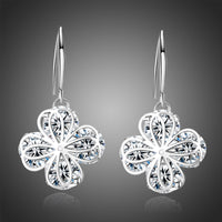 Side angle view of KHAISTA flower CZ drop earrings