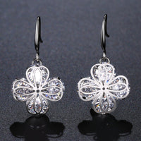 KHAISTA flower CZ drop earrings on white background
