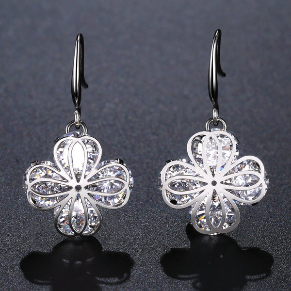 KHAISTA flower CZ drop earrings on white background