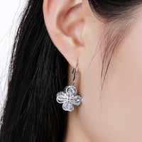 Close up of KHAISTA flower CZ drop earrings