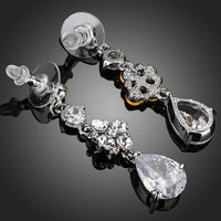 Close up of KHAISTA flower design CZ drop earrings