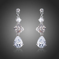 KHAISTA flower design CZ drop earrings on white background