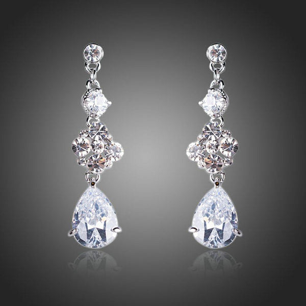 KHAISTA flower design CZ drop earrings on white background
