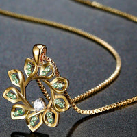 Close up detail of KHAISTA green CZ flower pendant necklace