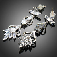 Side angle view of KHAISTA flower shape crystal drop earrings