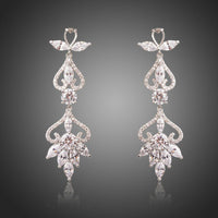 KHAISTA flower shape crystal drop earrings on white background