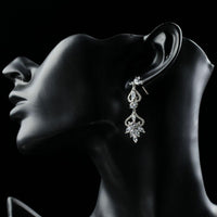 Close up of KHAISTA flower shape crystal drop earrings