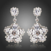 KHAISTA flower star CZ drop earrings on white background