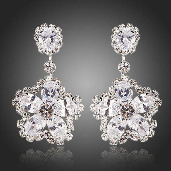 KHAISTA flower star CZ drop earrings on white background