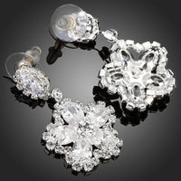 Close up of KHAISTA flower star CZ drop earrings