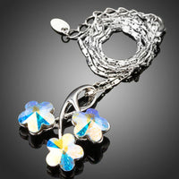 Side angle view of KHAISTA flower long chain pendant necklace