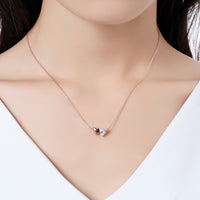 Close up detail of KHAISTA forever love double heart pendant necklace