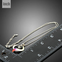 Side angle view of KHAISTA forever love crystal heart pendant necklace