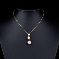 Side angle view of KHAISTA freshwater pearl pendant necklace