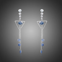 KHAISTA geometric blue crystal long drop earrings on white background