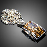 Close up detail of KHAISTA geometric champagne crystal pendant necklace
