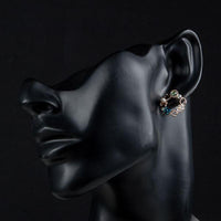 Side angle view of KHAISTA geometric circle crystal stud earrings