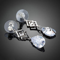 Close up of KHAISTA geometric CZ earrings