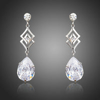 KHAISTA geometric CZ earrings on white background