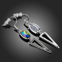 Close up of KHAISTA geometric design crystal drop earrings