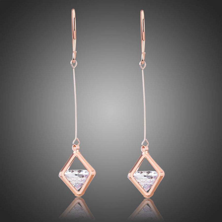 KHAISTA geometric hollow dangle earrings on white background