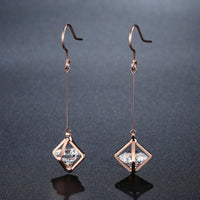 Close up of KHAISTA geometric hollow dangle earrings