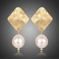 KHAISTA geometric pearl waterdrop dangle earrings on white background