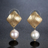 Close up of KHAISTA geometric pearl waterdrop dangle earrings