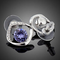 Close up of KHAISTA geometric sea blue crystal stud earrings