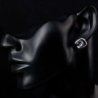 Side angle view of KHAISTA geometric sea blue crystal stud earrings