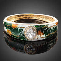 KHAISTA gold plated artistic paved cuff bangle on white background