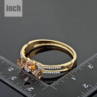 Close up detail of KHAISTA gold plated caramel crystal bangle