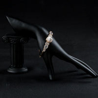 Side angle view of KHAISTA gold plated CZ bracelet bangle