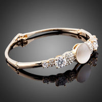 Close up detail of KHAISTA gold plated CZ bracelet bangle