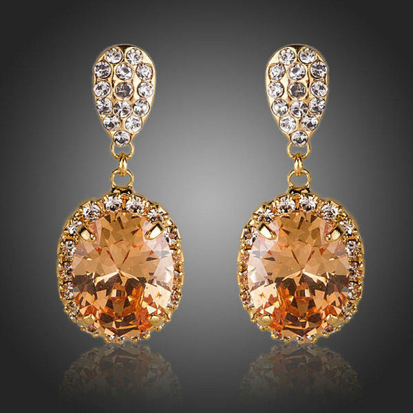 KHAISTA gold plated caramel CZ drop earrings on white background