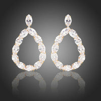 KHAISTA gold plated CZ chain drop earrings on white background