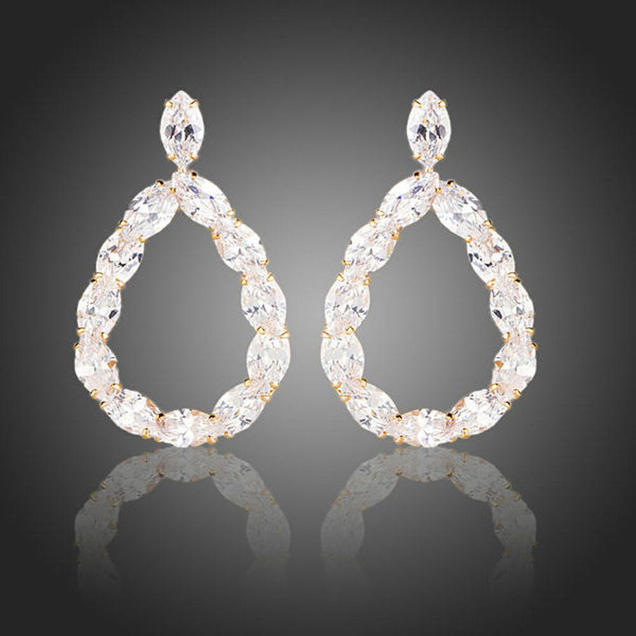 KHAISTA gold plated CZ chain drop earrings on white background