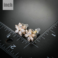 gold plated CZ flower shaped stud earrings detail view by KHAISTA