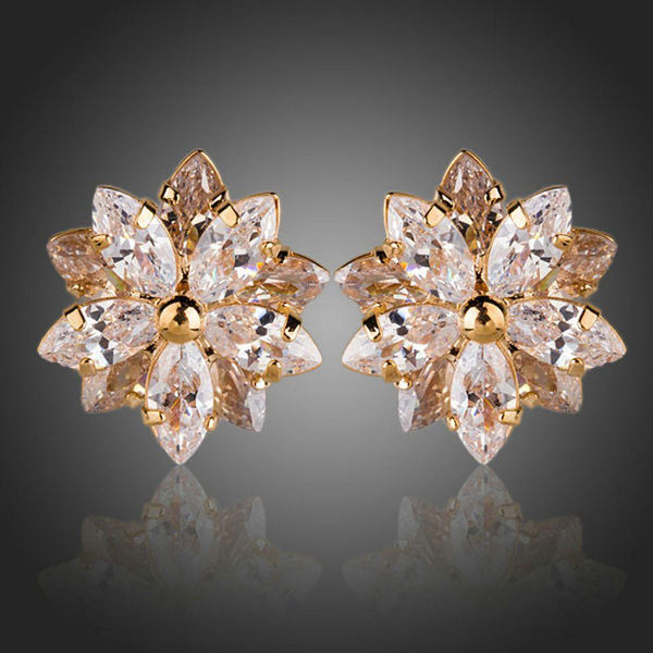 KHAISTA gold plated CZ flower shaped stud earrings on white background