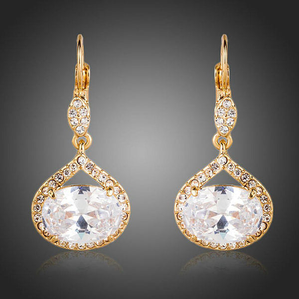 KHAISTA gold plated CZ love drop earrings on white background